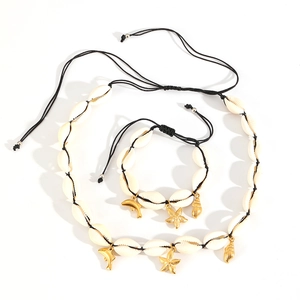 Natural shell jewelry set with gold starfish and dolphin charms on black woven cords