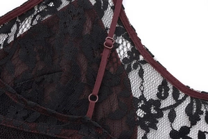 Close-up of black floral lace with burgundy trim and adjustable straps on lingerie dress