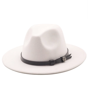 Detail of white wool fedora hat featuring black leather band and silver floral buckle