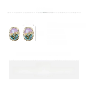 Detail view of vintage oval earrings with tulip enamel, pearls and rhinestone specs