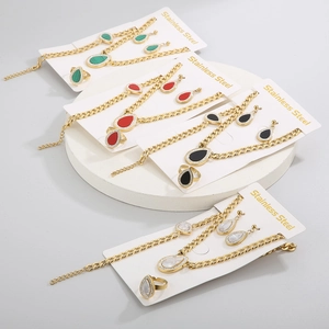 Detail view of 4-piece teardrop jewelry sets in four colors with gold steel chains