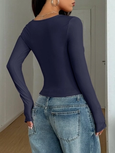 Rear view of tight-fitting dark blue long-sleeved t-shirt showing soft elastic fabric