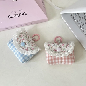 Close-up of floral lace earphone cases with plaid patterns and colorful hooks