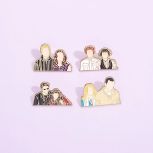 Close-up of four Twilight enamel pins featuring movie characters on purple background