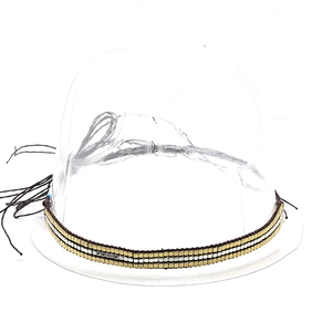 Close-up of three-row hand-woven metallic beaded belt band with gold and silver beads