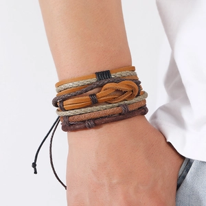 Close-up of vintage multi-layer braided leather bracelet set in brown and beige colors