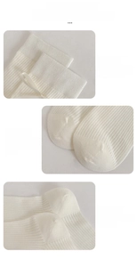 Detail display of white ballet style ribbed socks featuring silk ribbons and durable seams