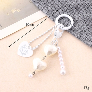 Detail of 10cm resin heart charm with pearls and matte white heart pendant for bags