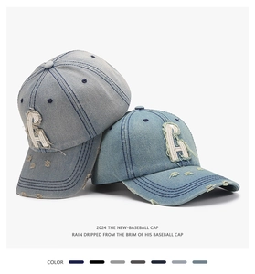 Macro shot of retro distressed denim cap featuring vintage frayed letter R patch and ripped brim