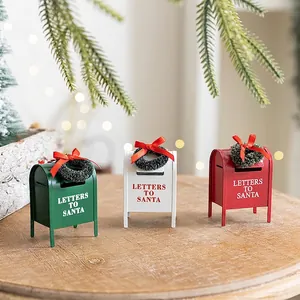Three metal Christmas mailbox ornaments in red, white and green with mini wreaths
