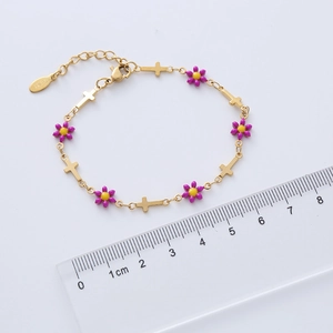 Detail of 18k gold plated chain bracelet with purple enamel flowers and steel crosses