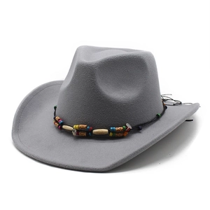 Close-up of grey felt cowboy hat with bohemian beaded band and wide curved brim