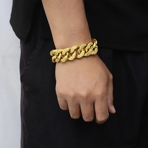 Close-up of golden stainless steel bracelet with peanut texture links on male wrist