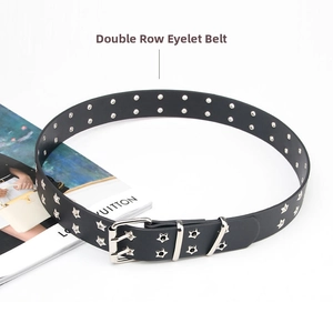 Close-up of black punk belt with double-row eyelets and silver star metal rivets