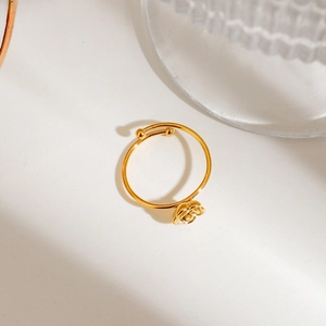 Macro shot of gold-plated 3D rose flower on an adjustable open ring with beads