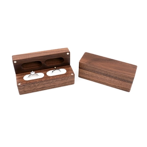 Detail of walnut wood double ring box with white velvet lining and magnetic closure
