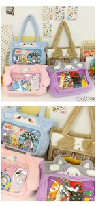 Pile of colorful plush Itabags with large PVC windows in blue, pink, and brown