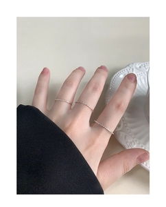 Close-up of minimalist S925 sterling silver 1mm thin shimmering rings on model's hand