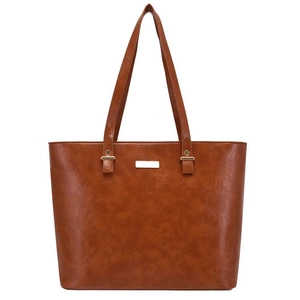 Close-up of brown PU leather tote bag with fine grain texture and gold brand plate
