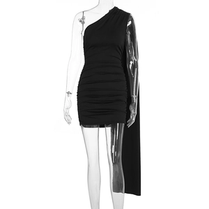 Detail of black one-shoulder ruched mini dress featuring a long flowing shoulder sash