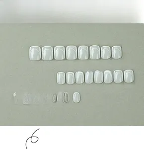 Detailed set of 24 short white French press-on nails with minimalist curved line designs
