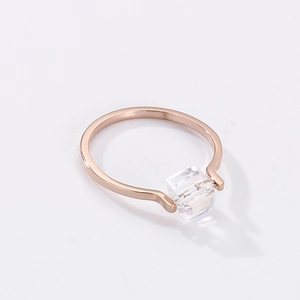 Macro shot of rose gold ring featuring a square-cut sparkling transparent cubic zirconia stone