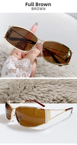 Detail of Y2K futuristic golden metal frame sunglasses with brown lenses and hollowed arms