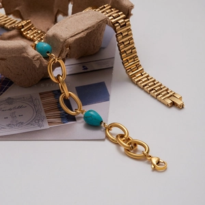 Detail of vintage 18K gold stainless steel chain bracelet with turquoise beads