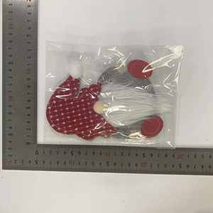 Macro detail of Christmas gnome cutlery bag with dimensions shown by measuring rulers