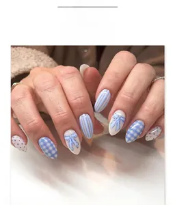 Detail of blue checkerboard and bow knot press-on nails in short almond shape