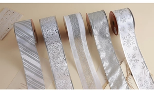 Detail of silver Christmas ribbons with glitter snowflakes and elegant mesh textures