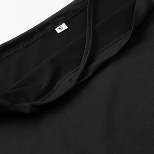 Detailed close-up of double-stitched neckline and size S label on black knit fabric