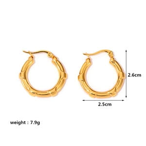 Detail view of gold hoop earrings with textured segments and 26mm diameter dimensions