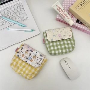 Close-up of quilted plaid mini storage pouches with cute bear and rabbit prints