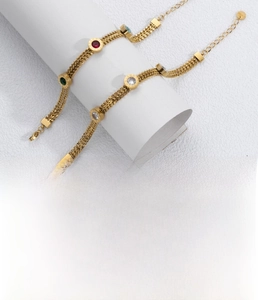 Detailed close-up of gold titanium steel chain featuring colorful zircons and Roman numerals