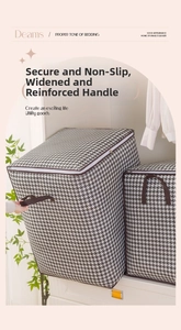 Close-up of houndstooth storage bag featuring reinforced wide handles and dual zippers