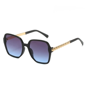 Fashionable oversized polygon sunglasses with black frames and purple-blue gradient lenses
