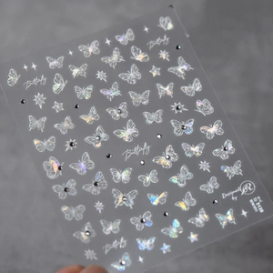 Detailed view of holographic butterfly nail stickers with stars and glitter on sheet