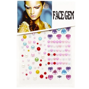 Macro view of multi-colored heart and pearl face gems on a transparent adhesive sheet