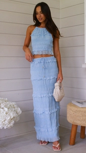 Detail of light blue sleeveless chiffon set featuring pleated texture and ruffle edges