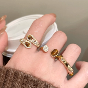 Detailed view of 18K gold plated tiger eye stone peanut ring with zircon inlays