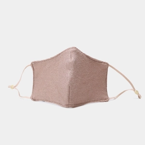Detail of dusty rose knitted face mask with adjustable ear loops and ribbed texture