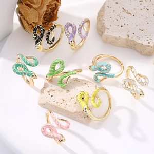 Detail view of eight colorful snake rings with enamel texture and scale pattern