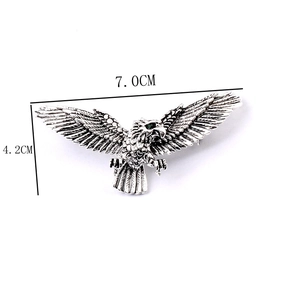Detailed eagle brooch view showing dimensions 7.0cm by 4.2cm with green stone eyes