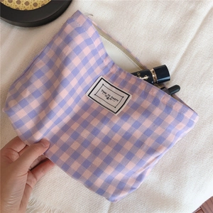Close-up of blue and purple plaid cotton makeup bag with Time to Party patch