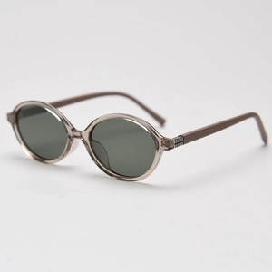 Close-up of retro oval sunglasses with transparent grey frame and dark lenses