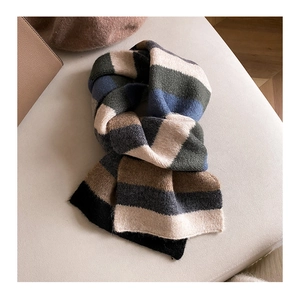 Close-up of soft rainbow mohair scarf with fluffy striped knit texture in multi-colors