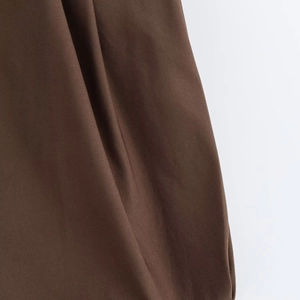 Detailed close-up of dark brown twill fabric showing premium texture and weave quality