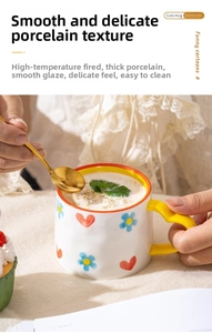 Close-up of ceramic heart mug with yellow handle filled with oatmeal drink for teatime