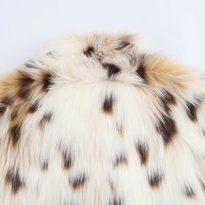 Close-up of soft leopard print faux fur texture on a warm autumn jacket for women